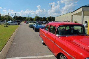 A red car is parked on the side of the road