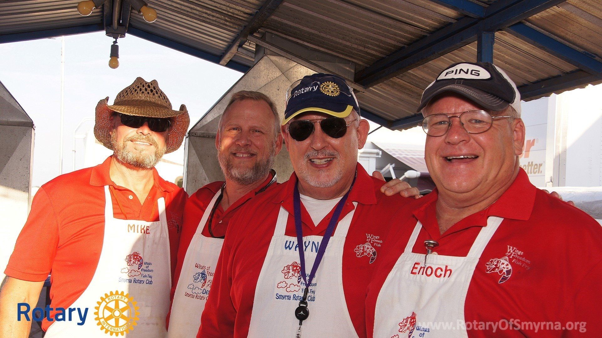 A group of men are posing for a picture with the word rotary on the bottom
