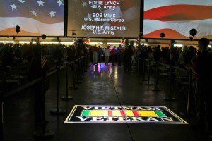 A large screen displays the name eddie lynch on it