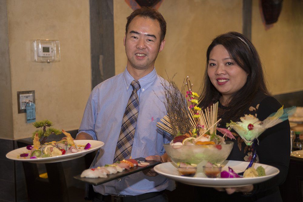Restaurant team presenting signature Japanese dishes at Volcano Steak & Sushi
