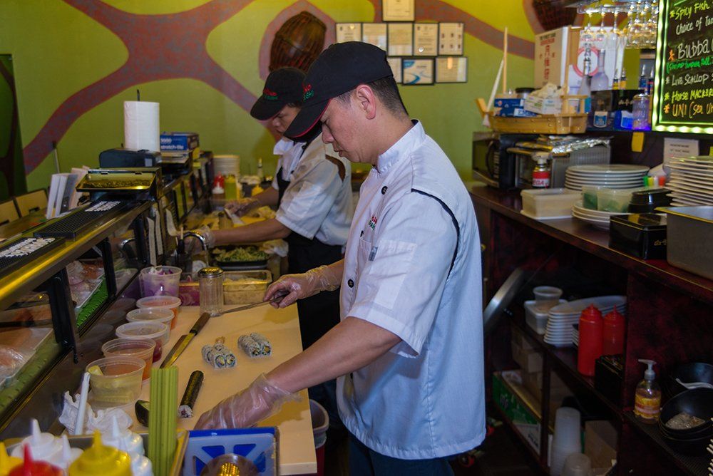 Sushi chef preparing fresh sushi at Volcano Steak & Sushi