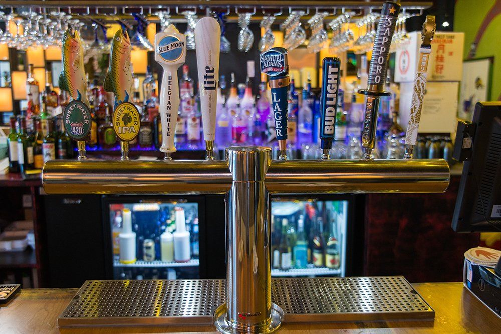 Bar featuring draft beer and cocktails at Volcano Steak & Sushi