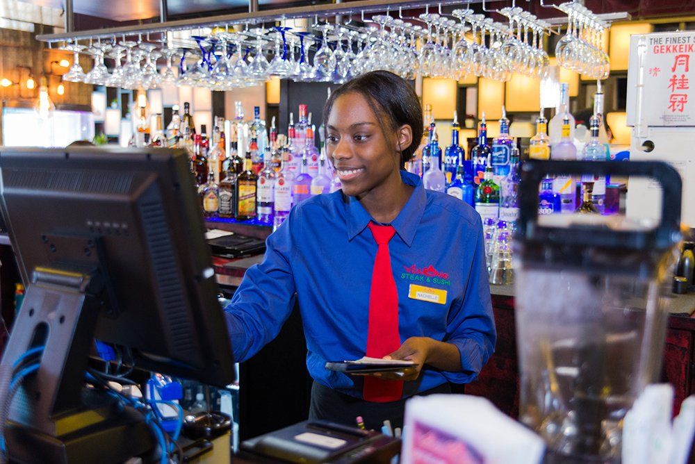 Friendly staff providing service at Volcano Steak & Sushi