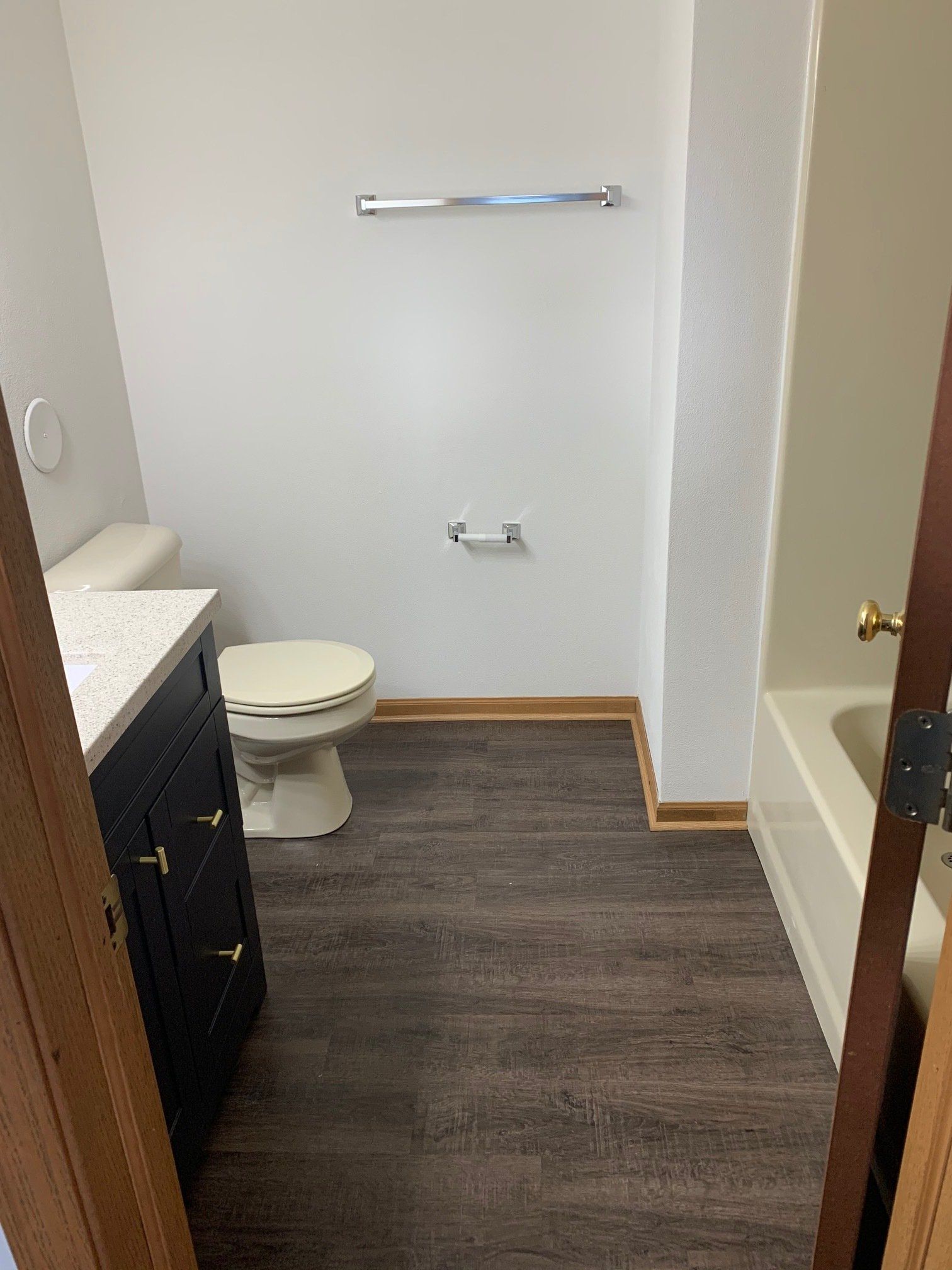 A bathroom with a toilet , sink , and bathtub.