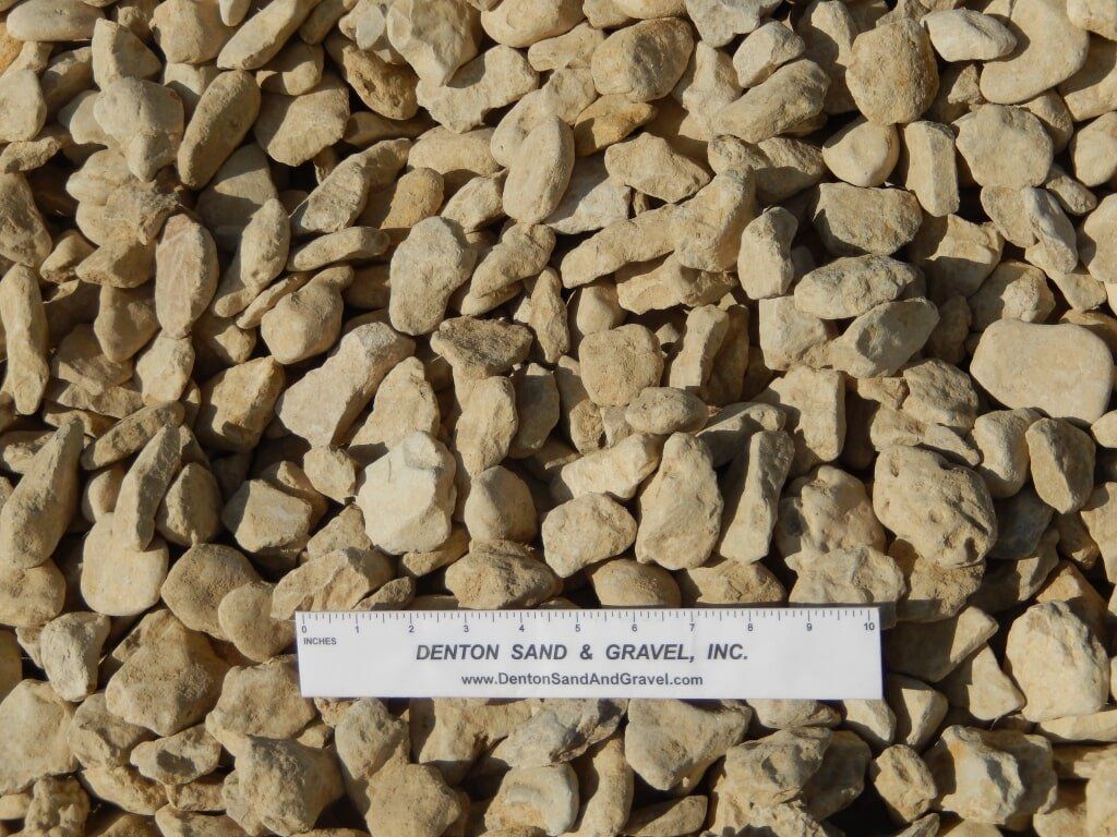 Tan gravel with a ruler laid across it for scale.