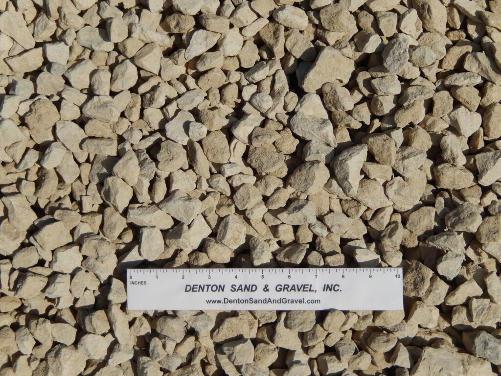 Tan gravel stones with ruler for scale.