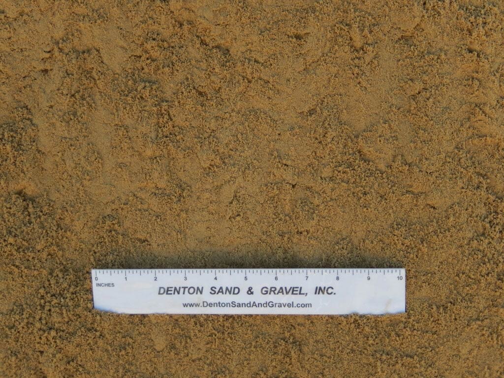Tan sand with a white ruler from Denton Sand & Gravel, Inc.
