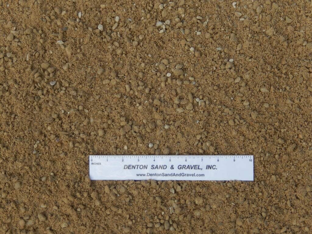 Tan-colored gravel with a ruler laid on top for scale.