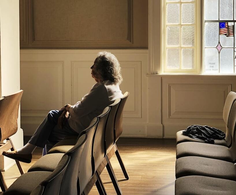 Widowed, lonely person sitting in a room