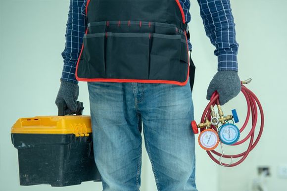 A Technician with Repair Tools — Delevan, WI — Karsten Heating & Cooling A Technician with Repair Tools — Delevan, WI — Karsten Heating & Cooling