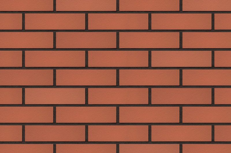 Red brick wall with dark mortar.