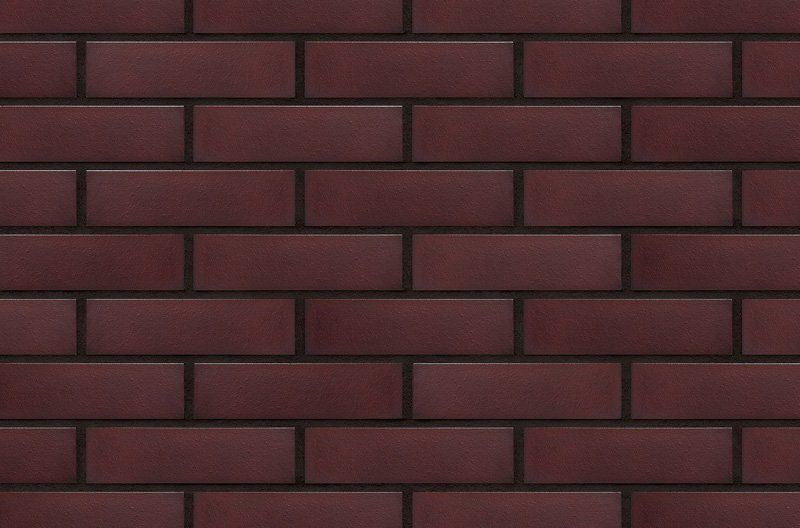 Dark red brick wall with black mortar.
