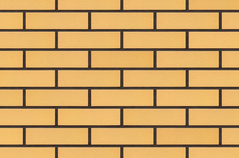 Yellow brick wall with dark brown mortar.