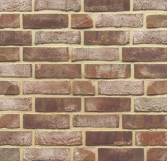 Close-up of a weathered brick wall in shades of brown and beige mortar.