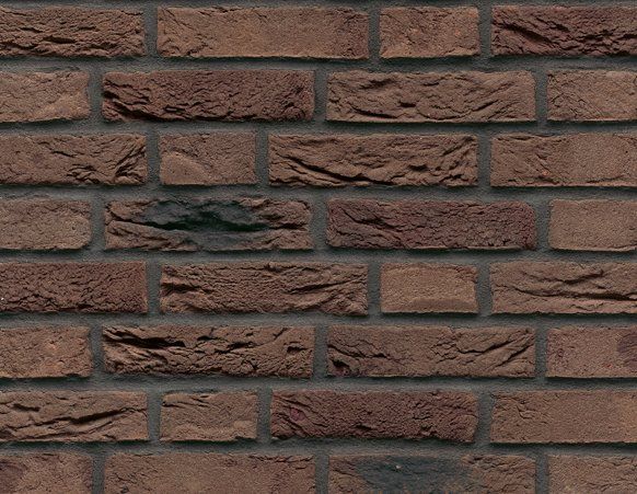 Close-up of a brick wall with varied shades of brown bricks and dark gray mortar.