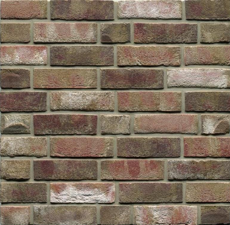 Brick wall with a pattern of varying shades of red, brown, and tan.