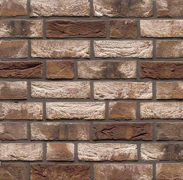 Brick wall texture with alternating beige and brown bricks.
