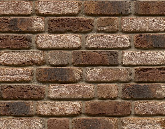 Brown and tan brick wall with varied tones and textures.