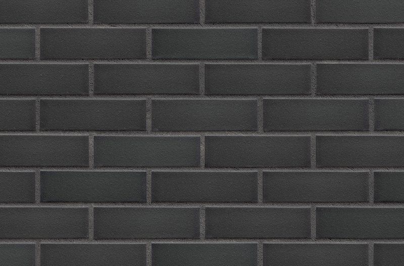 Black subway tile wall with gray grout.