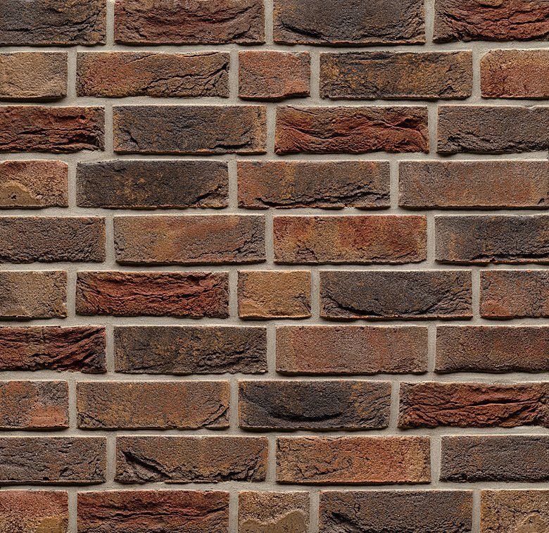 Brick wall, varying shades of brown and reddish-orange, with gray mortar between the bricks.