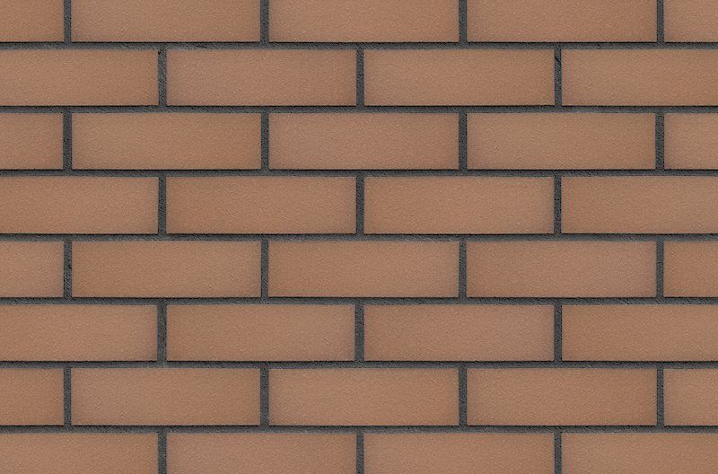 Brown brick wall with dark gray mortar.