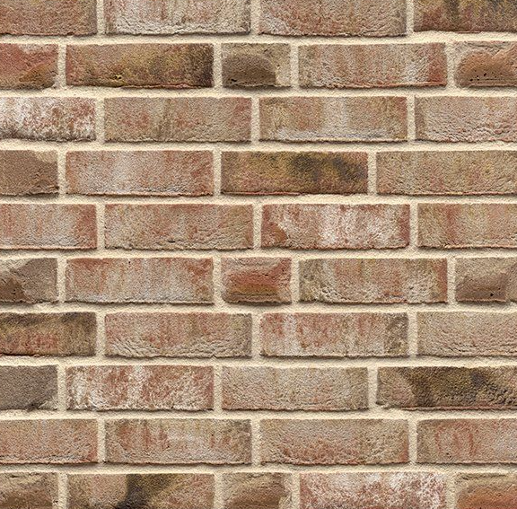 Close-up of a brick wall, with reddish-brown bricks and off-white mortar.