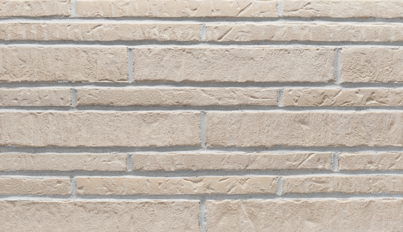 Beige brick wall with uneven surface and gray mortar lines.
