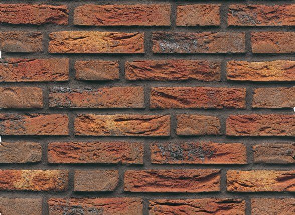Red and brown brick wall with rough texture and dark mortar.