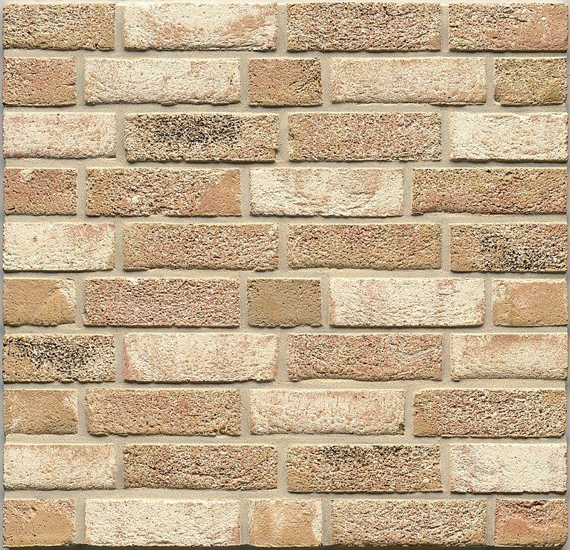 Brick wall, light tan and beige colors with mortar, textured surface.