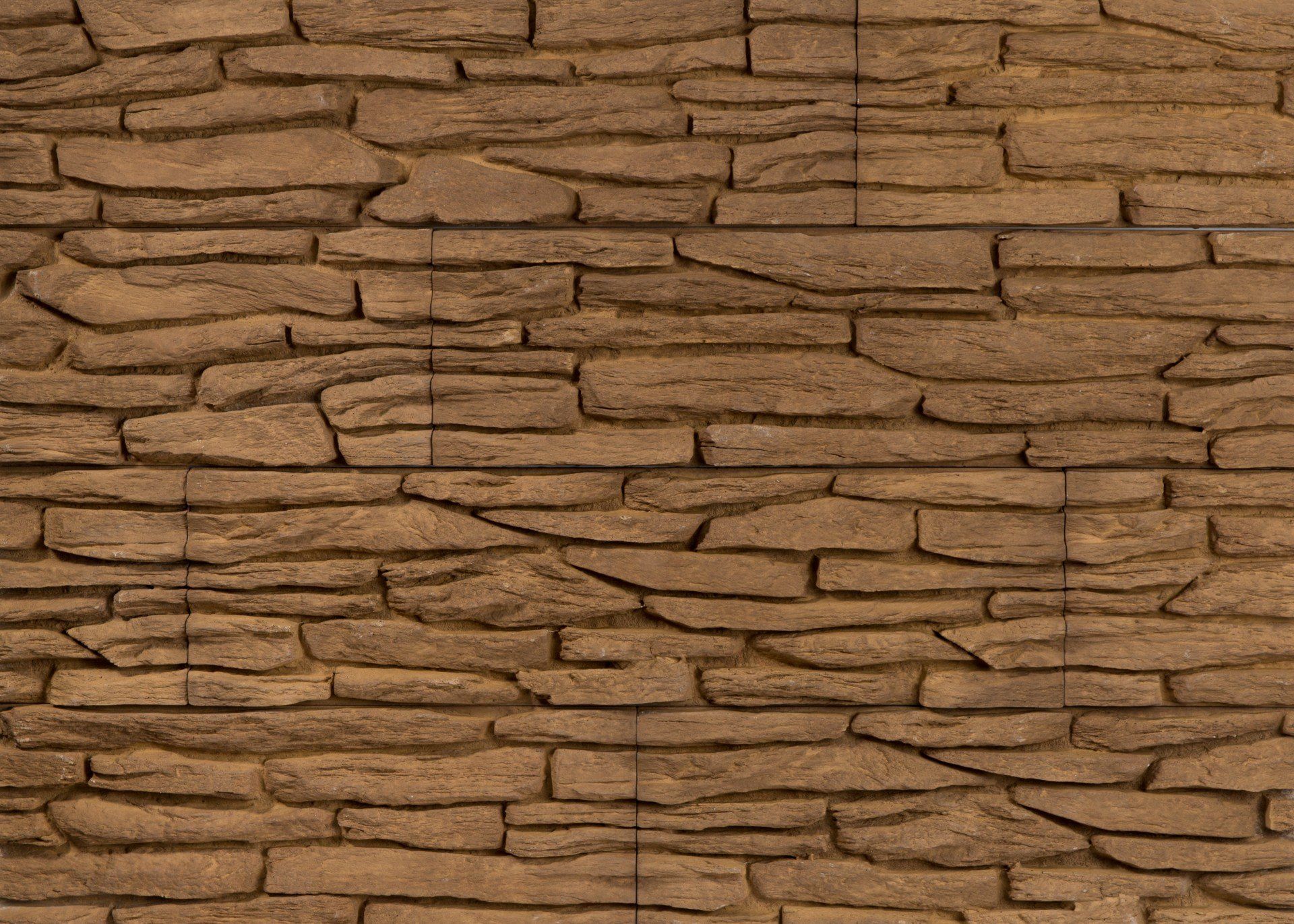 Brown stone wall with layered, textured appearance.
