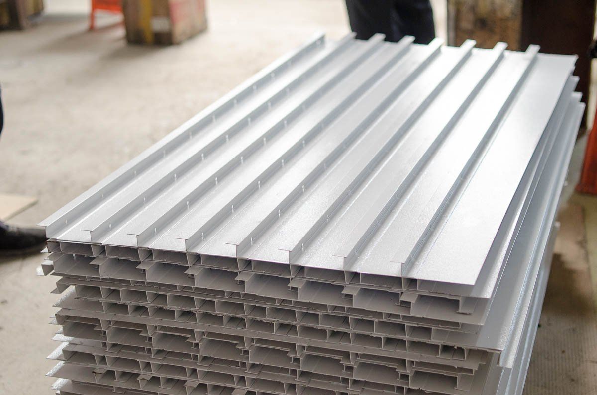 Stack of silver, grooved metal panels.