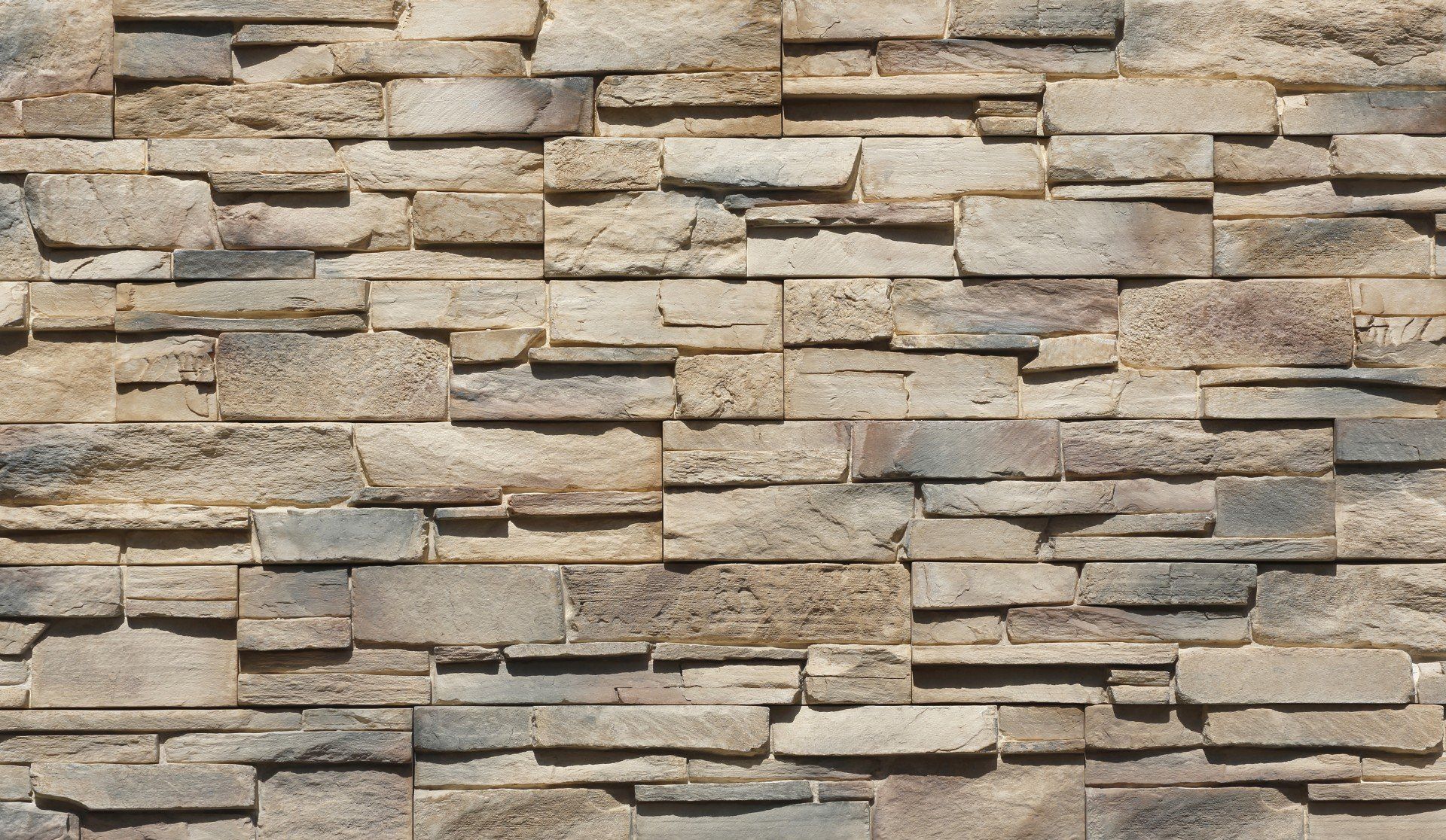 Stone veneer wall with varying shades of tan, brown, and gray rectangular stones.