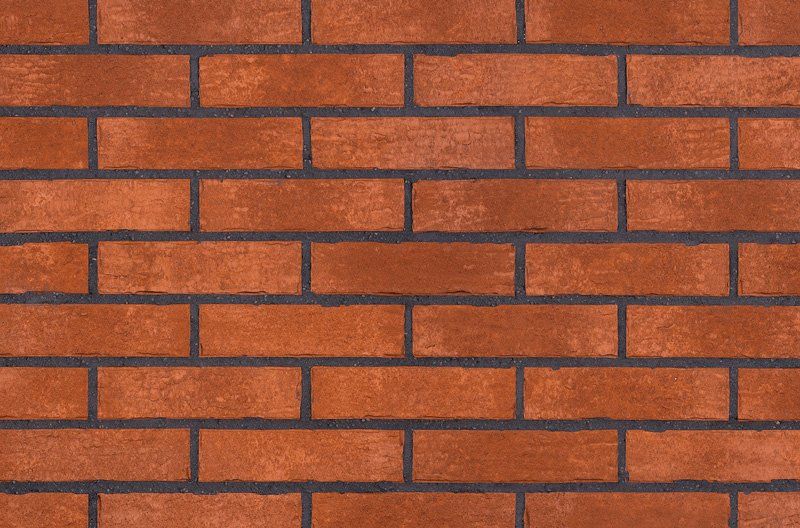 Red brick wall with dark mortar.