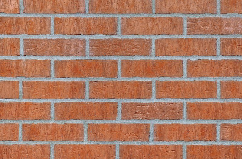 Red brick wall with white mortar.