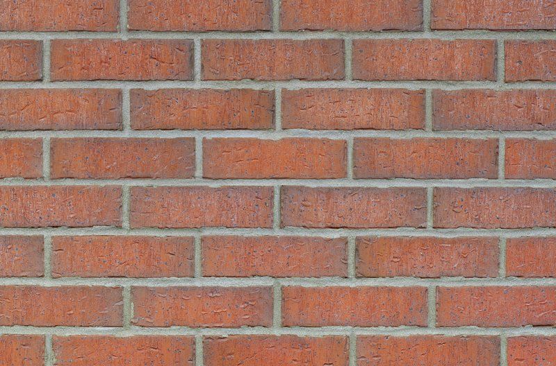 Red brick wall with gray mortar.