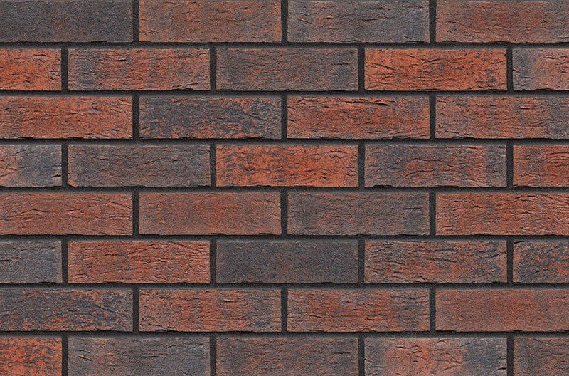 Brick wall with alternating dark and red-orange bricks.