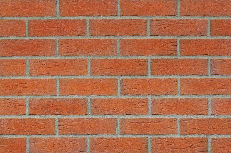 Red brick wall with gray mortar.