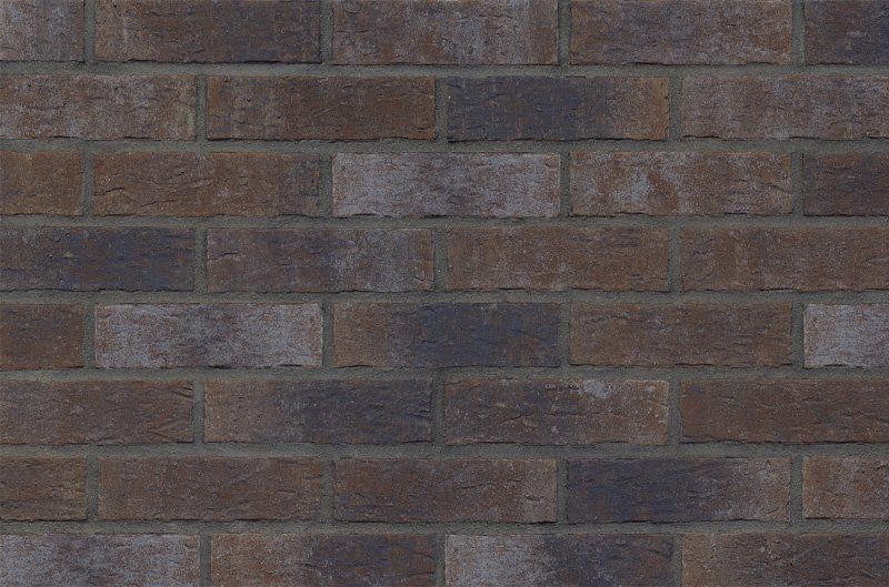 Brown and gray brick wall with mortar.