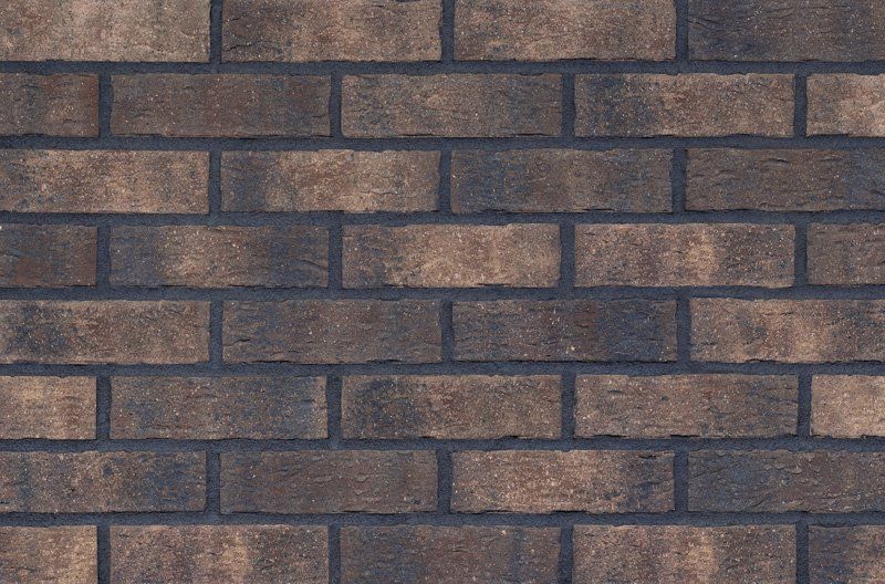 Brick wall with brown bricks and dark gray mortar.