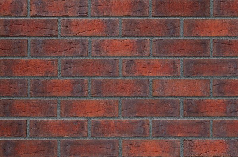 Red brick wall with dark mortar.