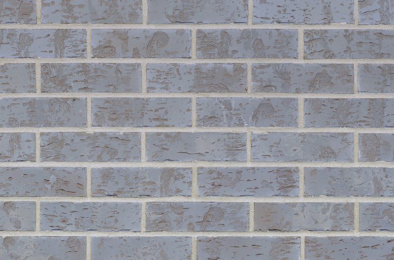 Gray brick wall with light-colored mortar.