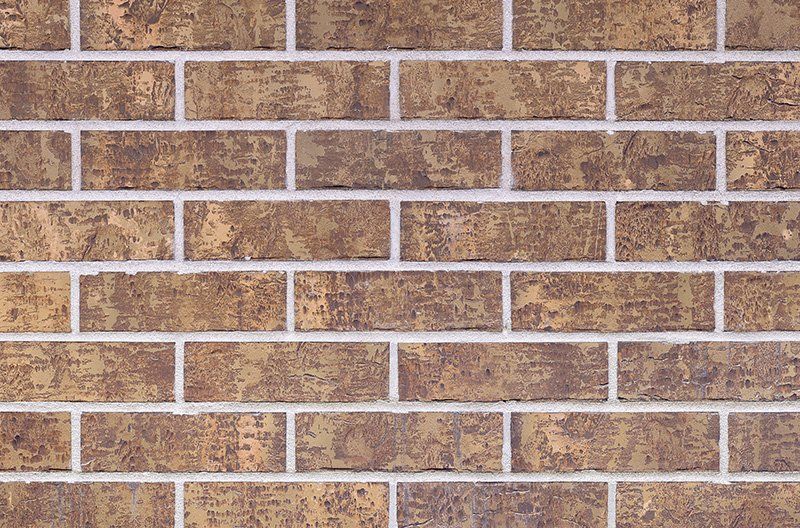 Brown brick wall with white mortar.