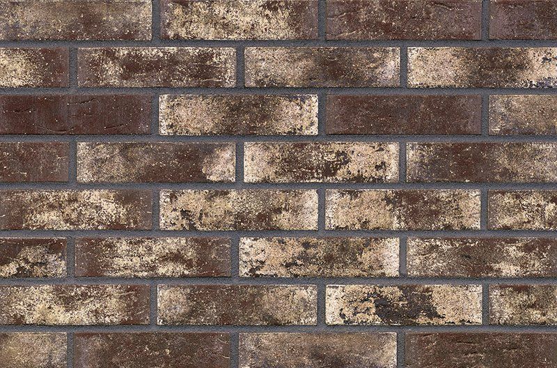 Brown and tan brick wall with gray mortar.