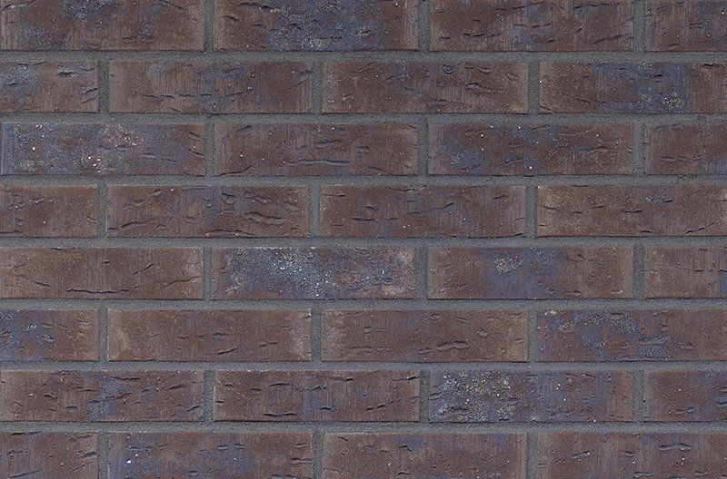 Dark brown and blue-gray brick wall with mortar joints.