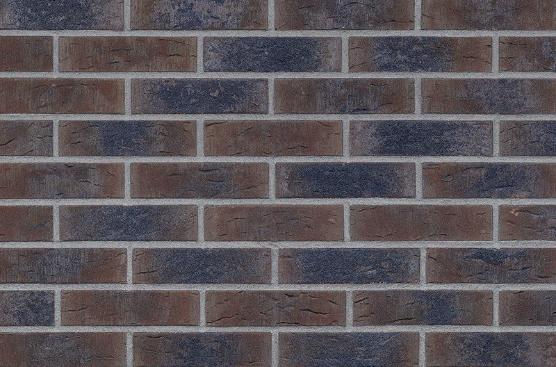 Brick wall texture, alternating brown and blue bricks with gray mortar.