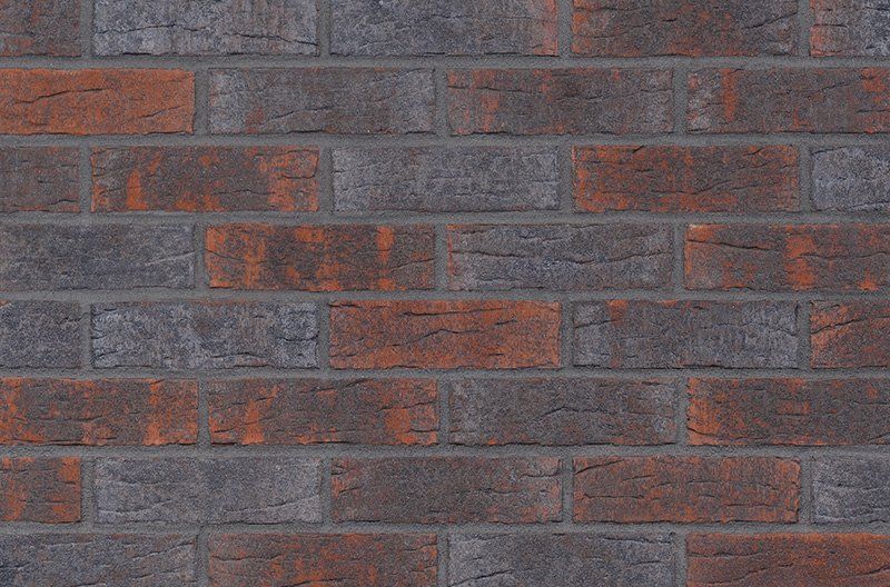 Brick wall with alternating dark grey and reddish-brown bricks.