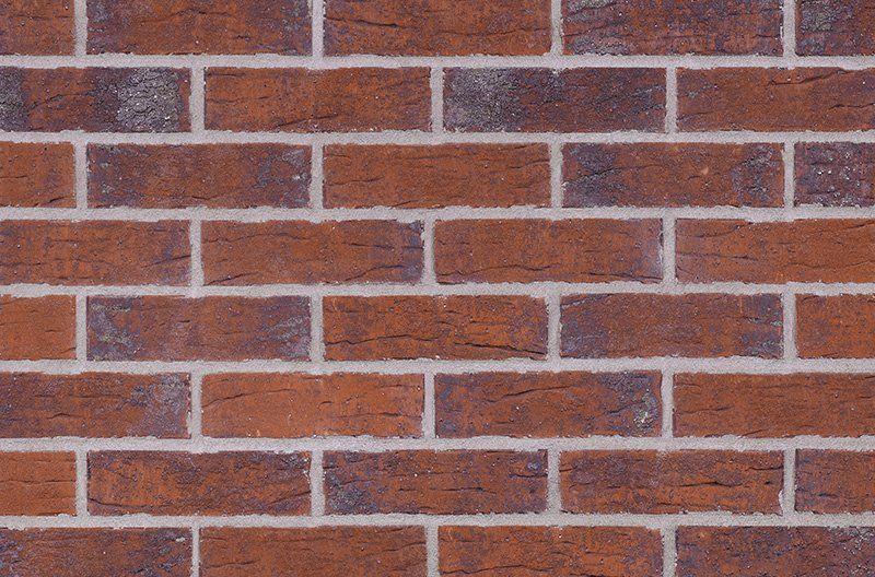 Red brick wall with white mortar.