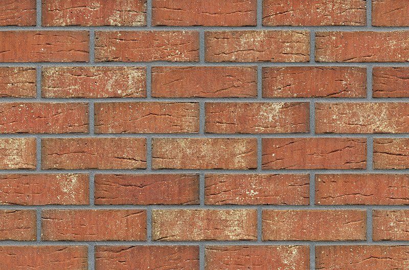 Red brick wall with gray mortar.