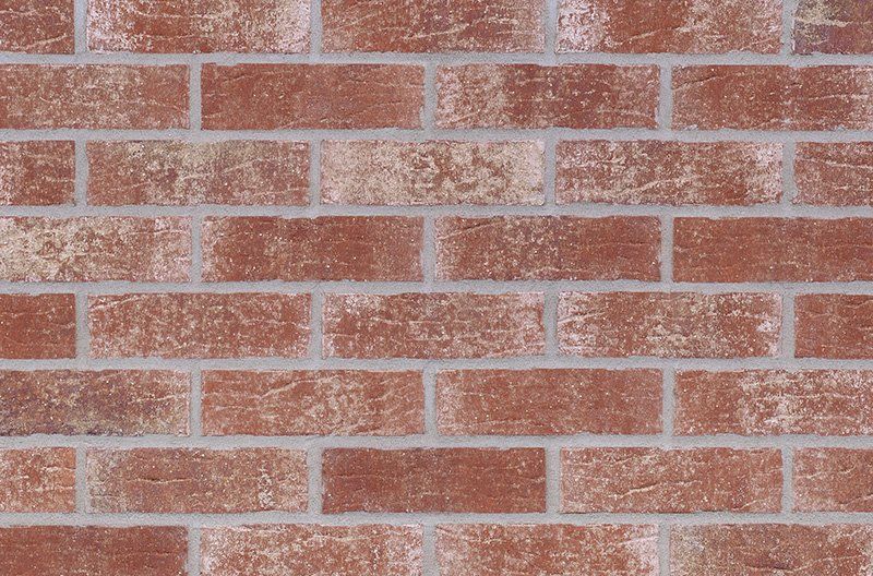 Red brick wall with light gray mortar.