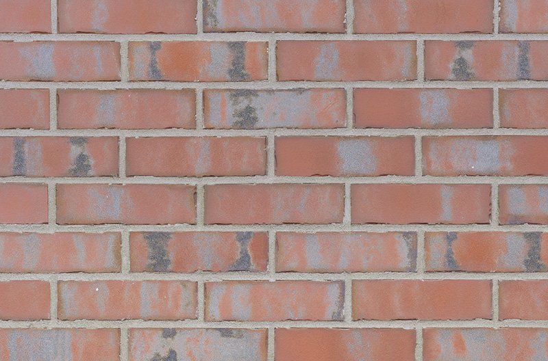 Red brick wall with gray mortar joints.